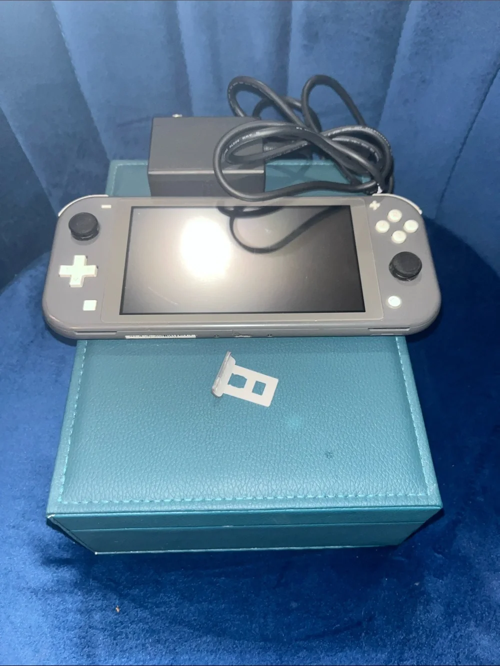 Gray and White Nintendo Switch Lite w/original Charger. Gently Used.